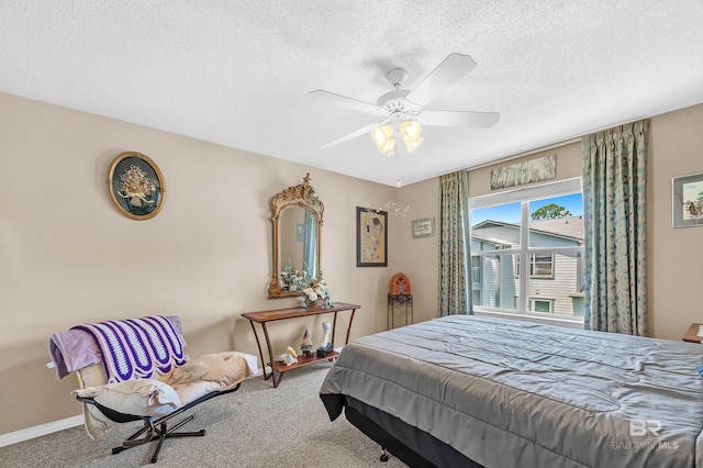 2200 W 2nd St Unit 301-C, Gulf Shores, AL 36542 - bedroom with carpet floors, a textured ceiling, and a ceiling fan