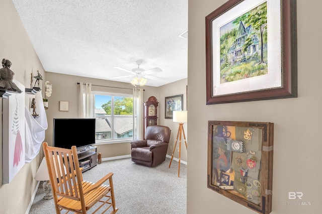 2200 W 2nd St Unit 301-C, Gulf Shores, AL 36542 - living area featuring carpet, a textured ceiling, and ceiling fan