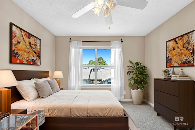 2200 W 2nd St Unit 301-C, Gulf Shores, AL 36542 - carpeted bedroom with a textured ceiling and ceiling fan