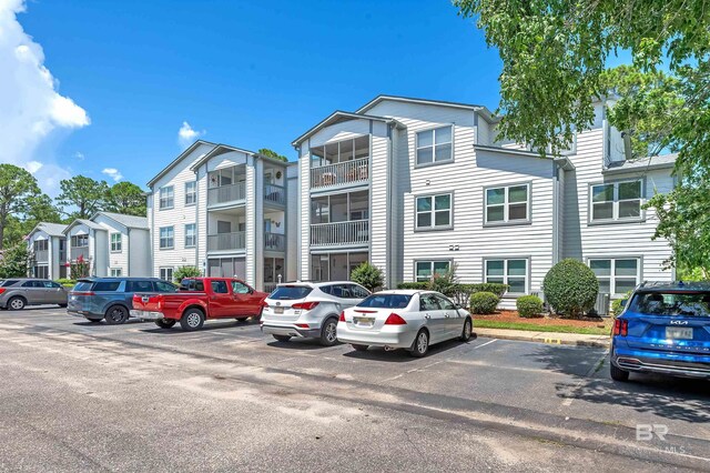 2200 W 2nd St Unit 301-C, Gulf Shores, AL 36542 - view of building exterior featuring uncovered parking