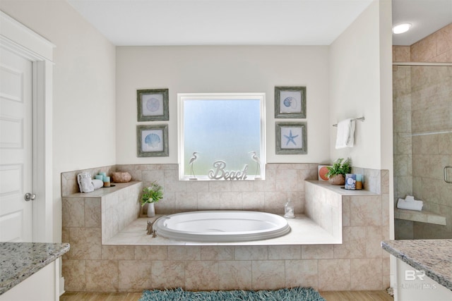 bathroom featuring hardwood / wood-style floors, vanity, and shower with separate bathtub