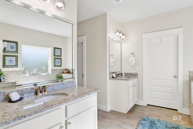 bathroom with vanity and hardwood / wood-style flooring