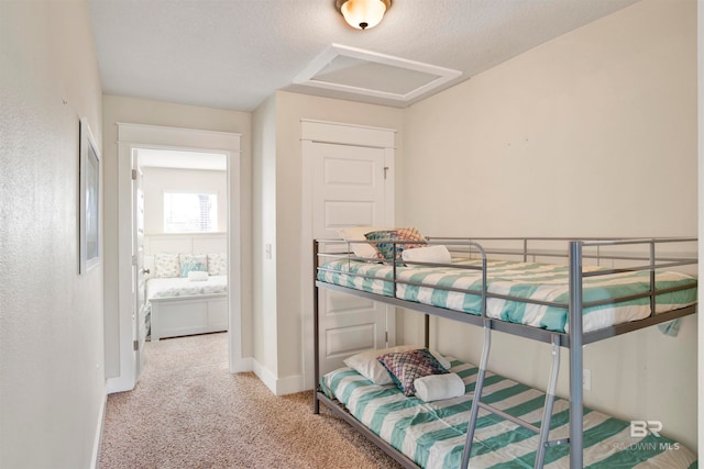 bedroom with carpet and a textured ceiling