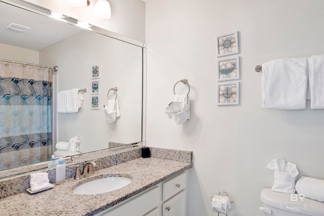 bathroom with vanity and toilet