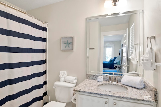 bathroom with vanity, toilet, and walk in shower