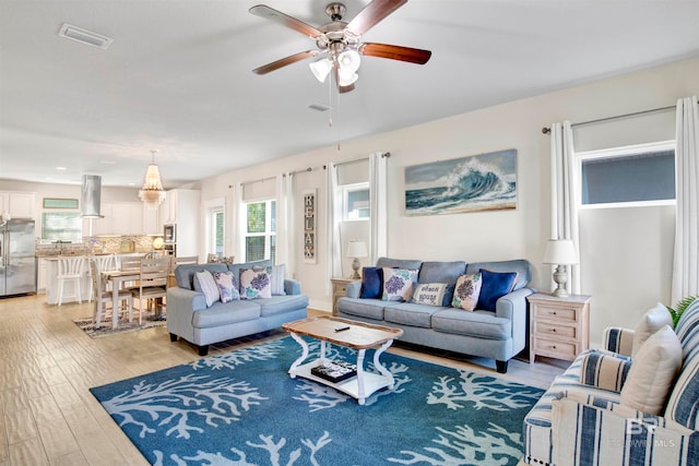 living room featuring ceiling fan and hardwood / wood-style floors