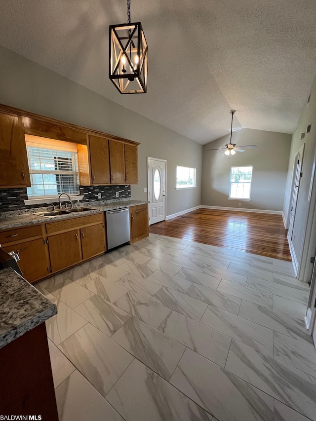 15082 County Road 93, Lillian, AL 36549 - kitchen with decorative light fixtures, dishwasher, ceiling fan with notable chandelier, light tile flooring, and vaulted ceiling
