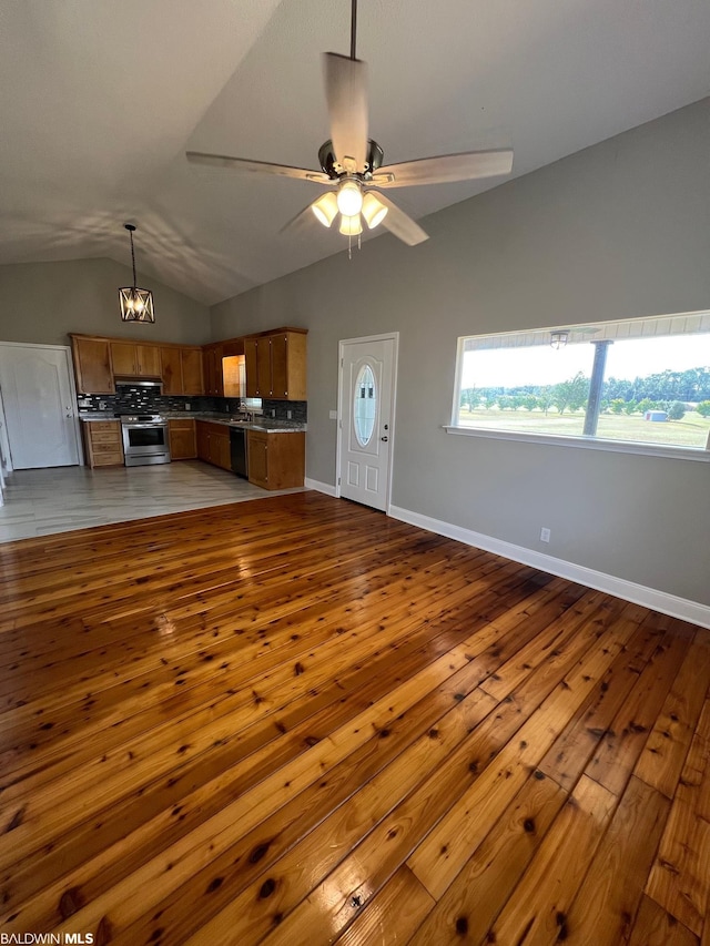 15082 County Road 93, Lillian, AL 36549 - unfurnished living room with lofted ceiling, light wood-type flooring, and ceiling fan with notable chandelier