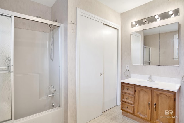 full bathroom with combined bath / shower with glass door, tile patterned floors, and vanity