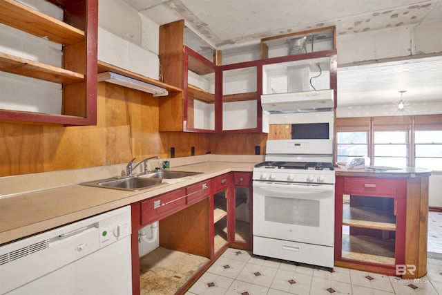 kitchen featuring light countertops, a sink, open shelves, and white appliances