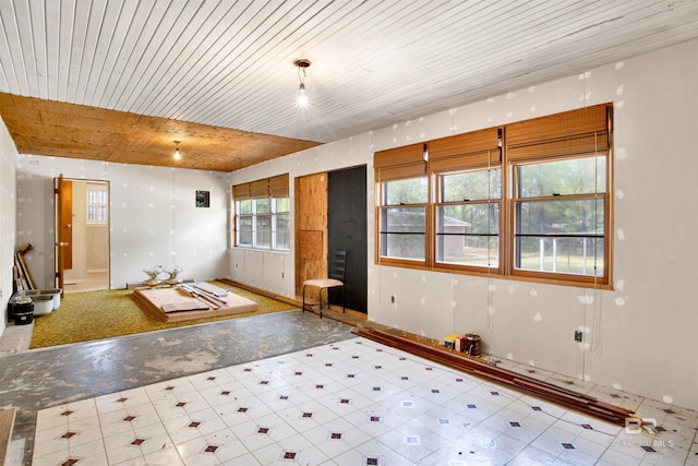 entryway with tile patterned floors and wooden ceiling