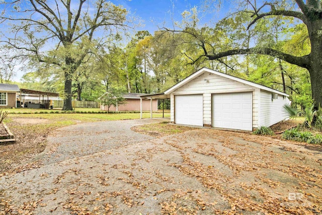 garage with fence and a garage