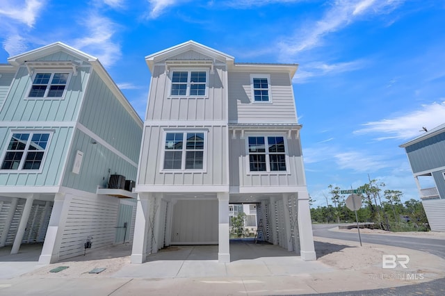 beach home with a carport, board and batten siding, and driveway