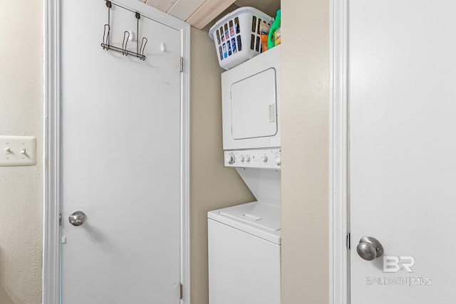 washroom with stacked washer and dryer