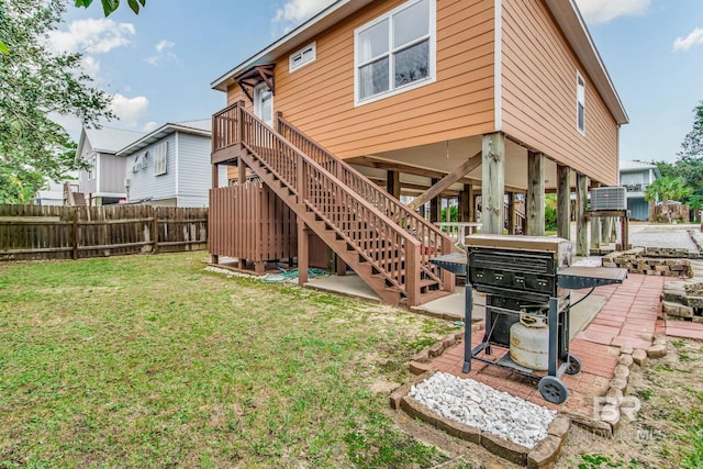 back of property with a yard, a patio, and a wooden deck