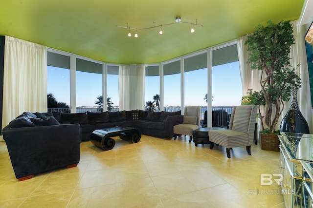 living room featuring plenty of natural light, expansive windows, and light tile patterned flooring