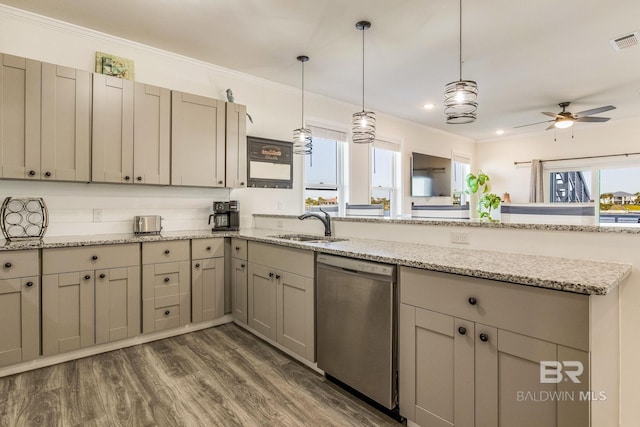 kitchen with dark wood-type flooring, light stone counters, dishwasher, and hanging light fixtures