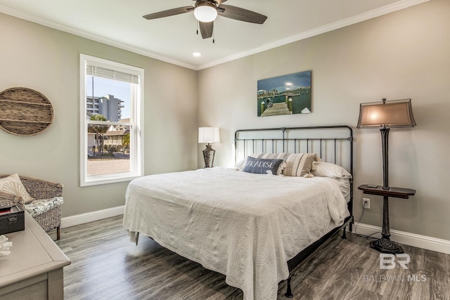 bedroom with ornamental molding, dark wood-type flooring, and ceiling fan