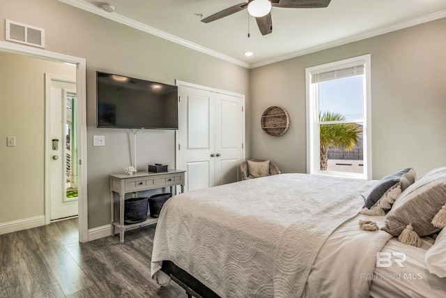 bedroom featuring dark wood-type flooring, ceiling fan, a closet, and ornamental molding