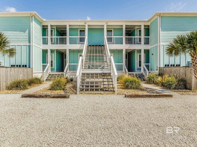 17290 Perdido Key Dr Unit A1, Pensacola, FL 32507 - view of front of house featuring board and batten siding, stairway, and fence