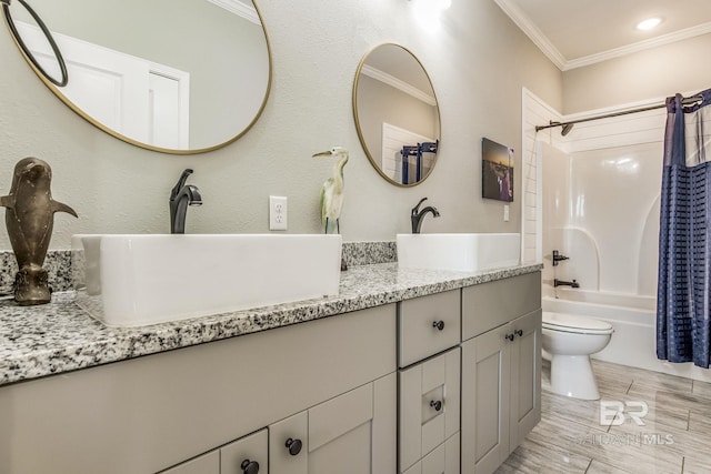 full bathroom with hardwood / wood-style floors, toilet, shower / bath combo with shower curtain, vanity, and crown molding