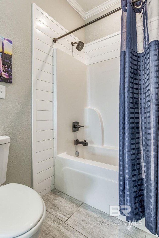 bathroom with toilet, ornamental molding, and shower / bathtub combination with curtain