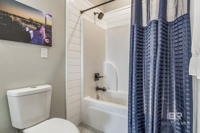 bathroom with shower / bath combination with curtain and toilet