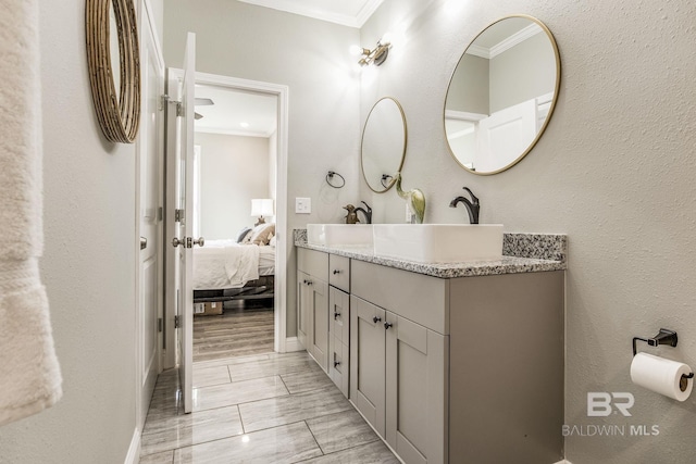 bathroom with vanity and ornamental molding