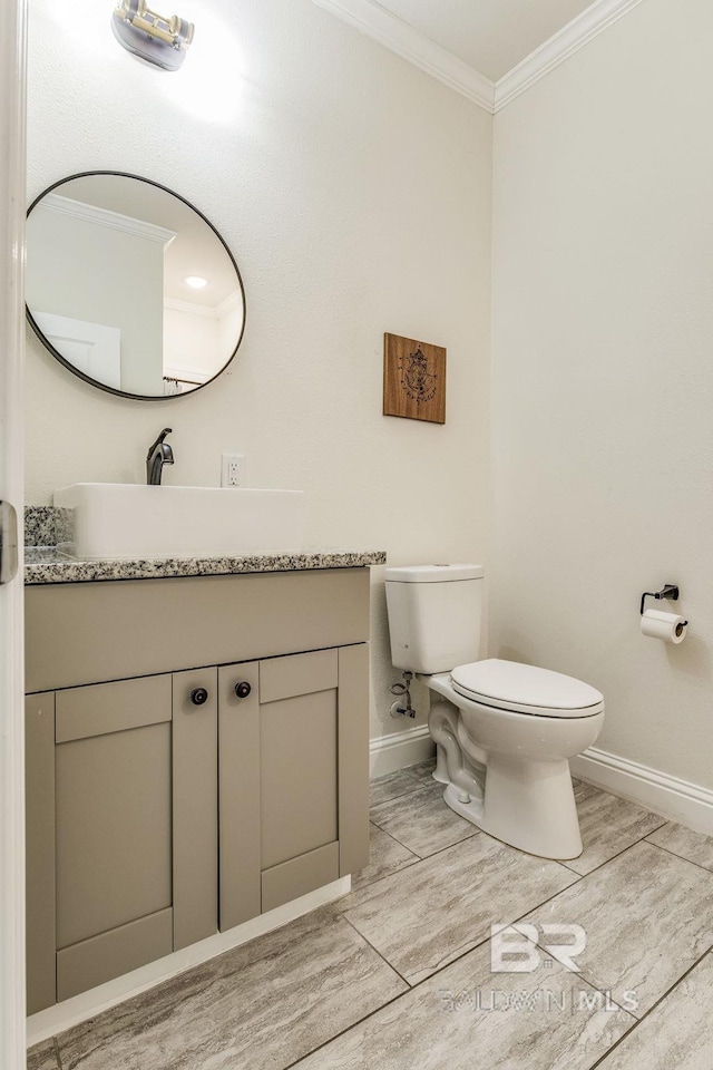 bathroom with toilet, crown molding, hardwood / wood-style floors, and vanity