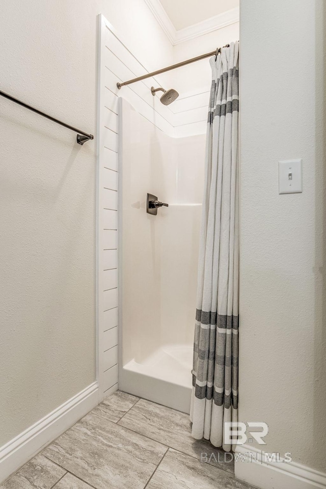 bathroom featuring hardwood / wood-style flooring, walk in shower, and ornamental molding