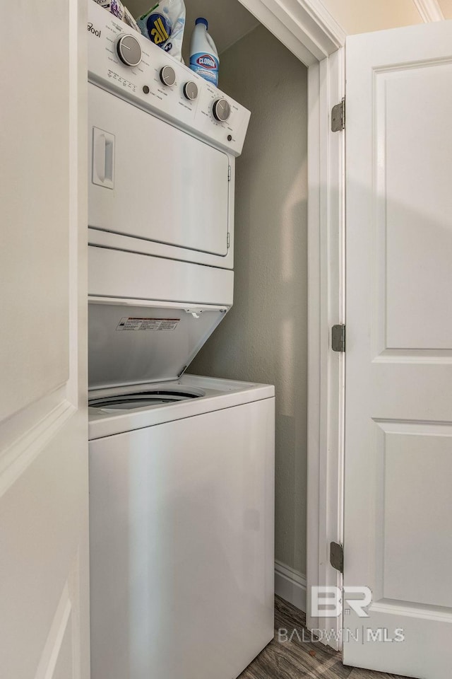17290 Perdido Key Dr Unit A1, Pensacola, FL 32507 - laundry room with dark wood finished floors, stacked washer / drying machine, and laundry area