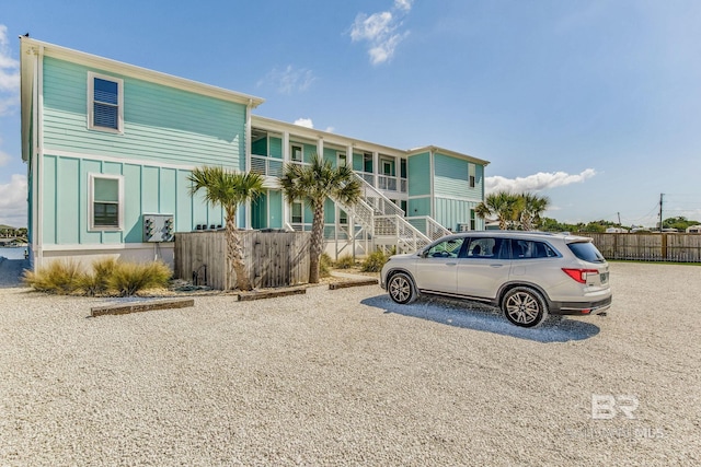 17290 Perdido Key Dr Unit A1, Pensacola, FL 32507 - view of front of home with board and batten siding, stairs, and fence