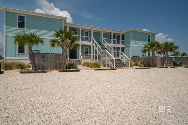 17290 Perdido Key Dr Unit A1, Pensacola, FL 32507 - back of house with stairway, a porch, and fence