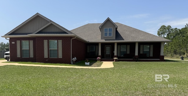 view of front facade featuring board and batten siding, a front lawn, brick siding, a porch, and a shingled roof