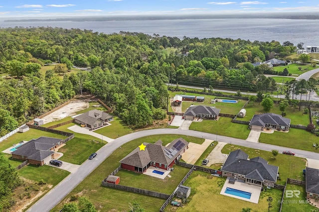 bird's eye view with a water view and a view of trees