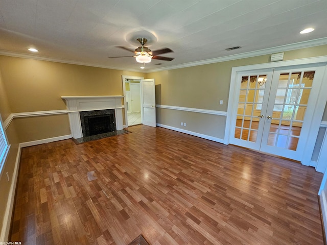 unfurnished living room featuring dark hardwood / wood-style flooring, ceiling fan, a high end fireplace, and french doors