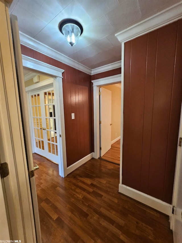 hallway featuring ornamental molding, dark wood-type flooring, and french doors