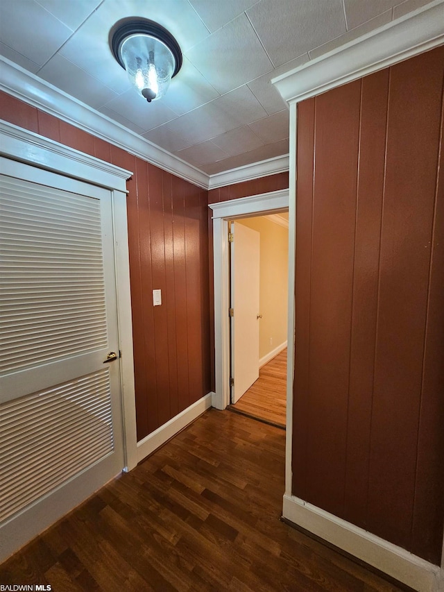 hall with crown molding and dark hardwood / wood-style flooring