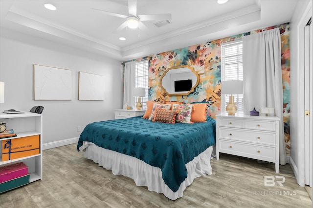 5570 Bay La Launch Ave, Orange Beach, AL 36561 - bedroom featuring ornamental molding, a tray ceiling, light wood-type flooring, baseboards, and recessed lighting