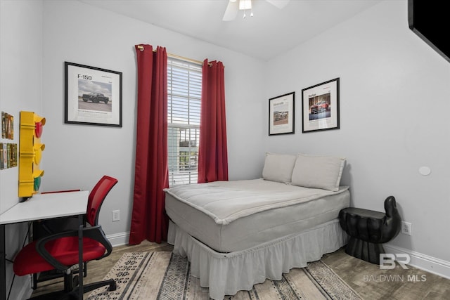 5570 Bay La Launch Ave, Orange Beach, AL 36561 - bedroom with wood finished floors, baseboards, a desk, and a ceiling fan