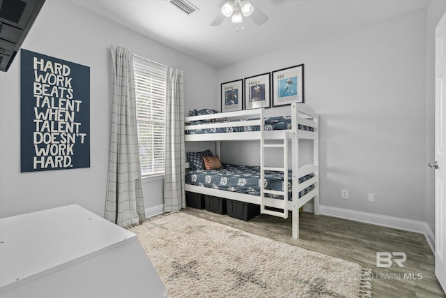 5570 Bay La Launch Ave, Orange Beach, AL 36561 - bedroom with multiple windows, baseboards, wood finished floors, and ceiling fan