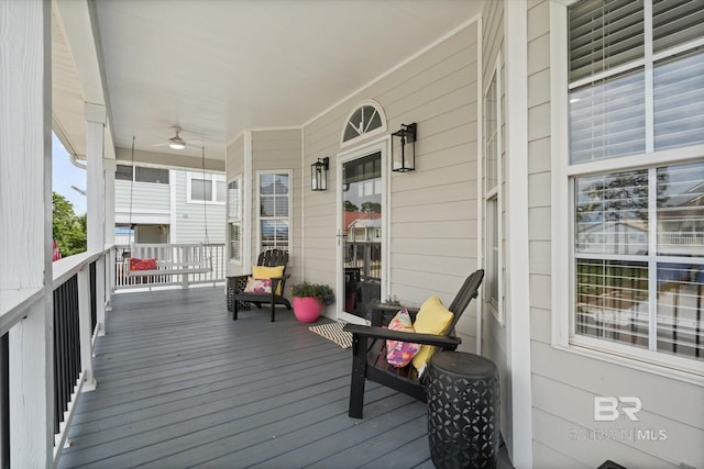 5570 Bay La Launch Ave, Orange Beach, AL 36561 - wooden deck featuring a ceiling fan and a porch