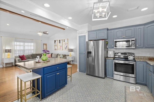5570 Bay La Launch Ave, Orange Beach, AL 36561 - kitchen with appliances with stainless steel finishes, a breakfast bar area, lofted ceiling, open floor plan, and blue cabinets