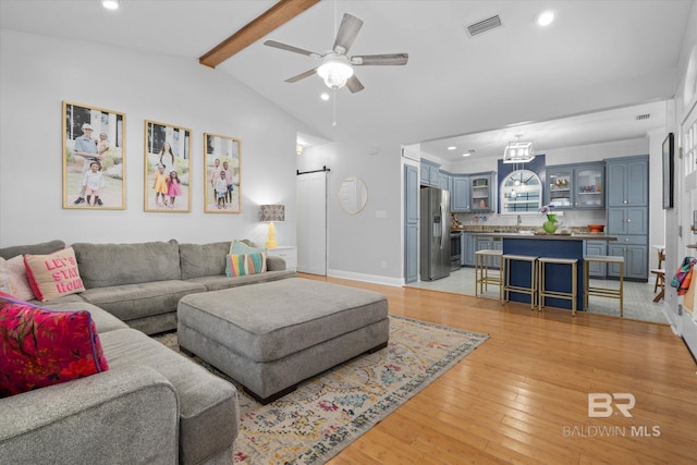 5570 Bay La Launch Ave, Orange Beach, AL 36561 - living room featuring recessed lighting, a ceiling fan, light wood-type flooring, a barn door, and baseboards