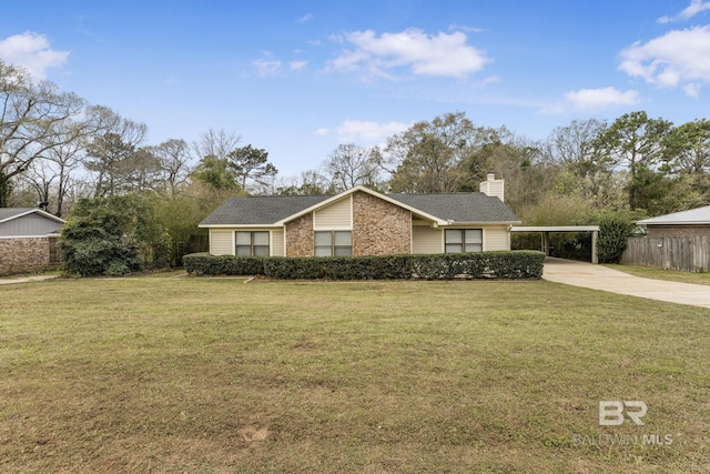 view of front of house featuring fence, driveway, a chimney, a front lawn, and a carport