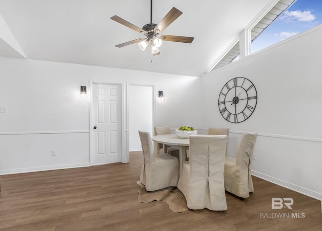 dining area featuring baseboards, wood finished floors, a ceiling fan, and vaulted ceiling