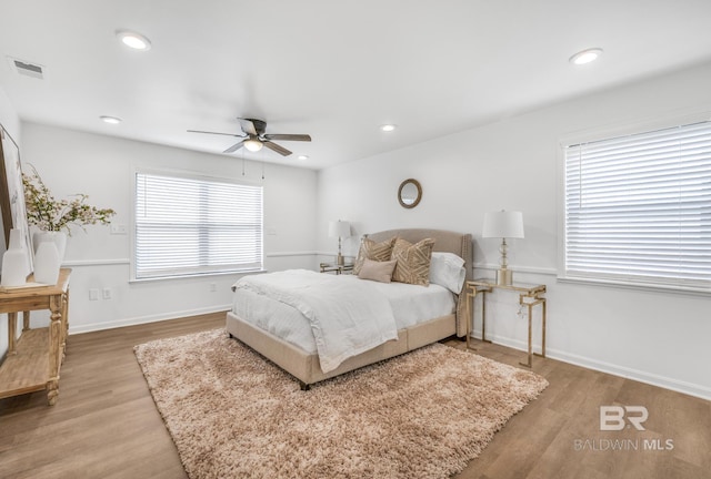 bedroom with wood finished floors, visible vents, baseboards, recessed lighting, and ceiling fan