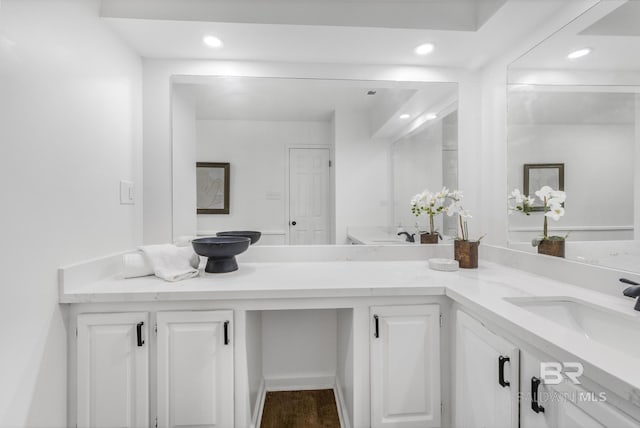 bathroom featuring a sink, recessed lighting, and double vanity