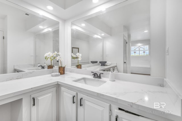 full bathroom featuring recessed lighting and vanity