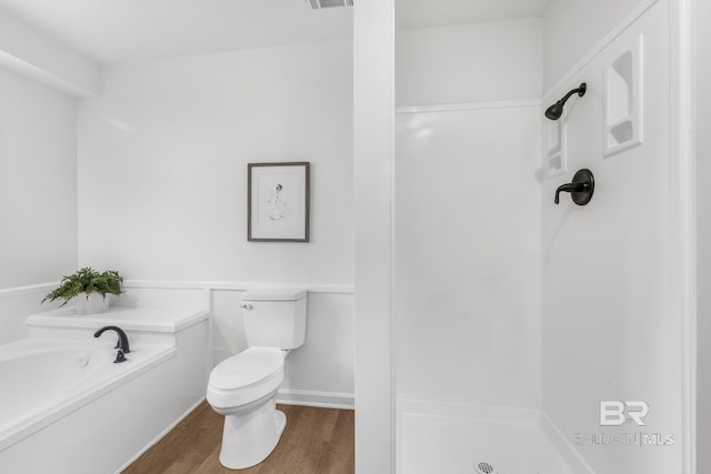 bathroom with visible vents, toilet, a garden tub, wood finished floors, and a shower stall